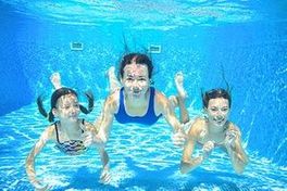 Family swim in pool underwater, happy active mother and children have fun under water, kids sport on family vacation- Clearwater Pools